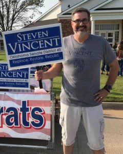 Man holds Steve Vincent sign