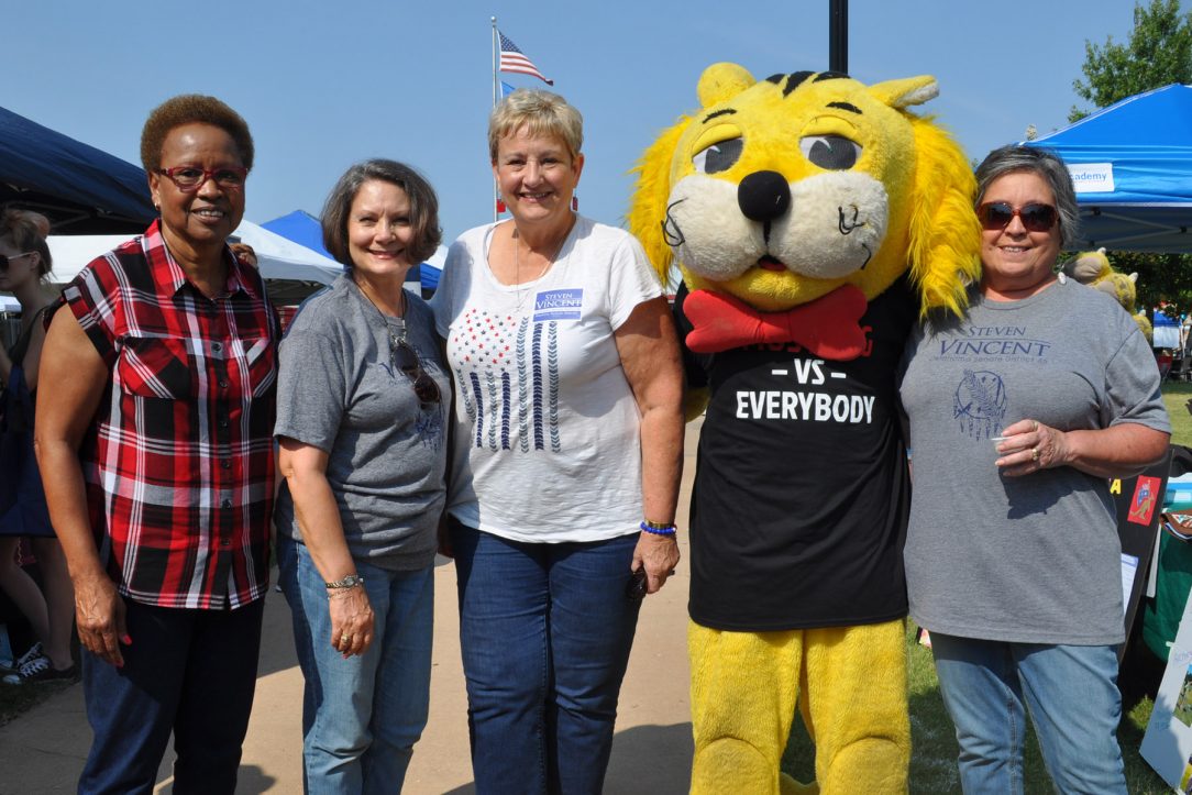 4 women pose with someone in a cat costume