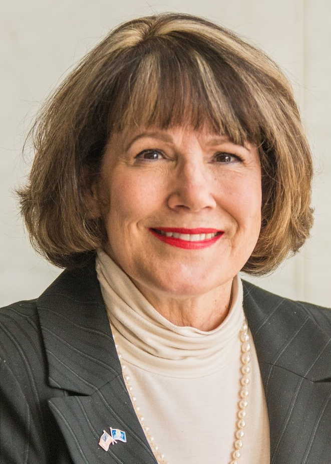 Smiling portrait of woman in a jacket and blouse